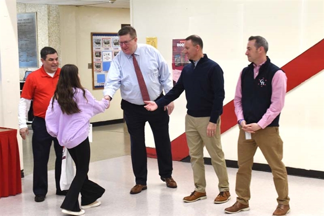 Student shaking hands with administration