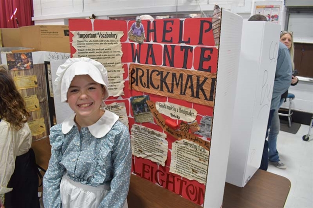student dressed up in colonial times smiling