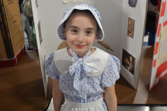 student dressed up in colonial times smiling