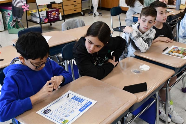 students conducting science experiment in class