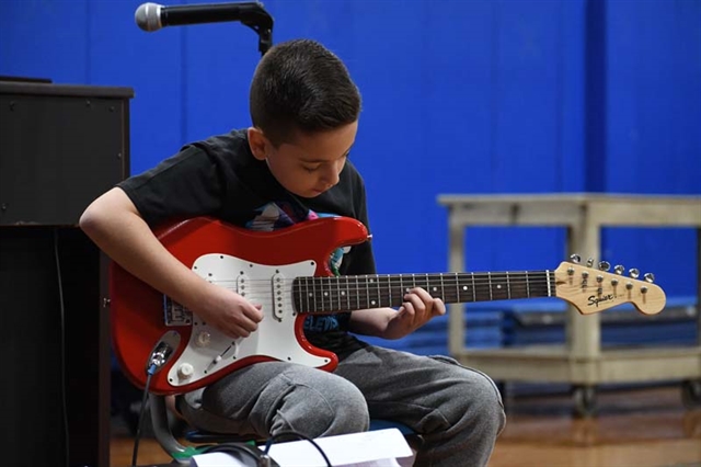 student playing guitar