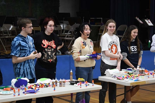 students helping make puppets