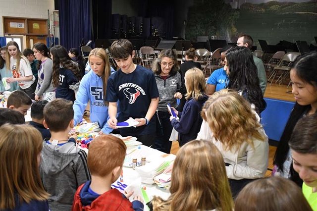 students helping make puppets