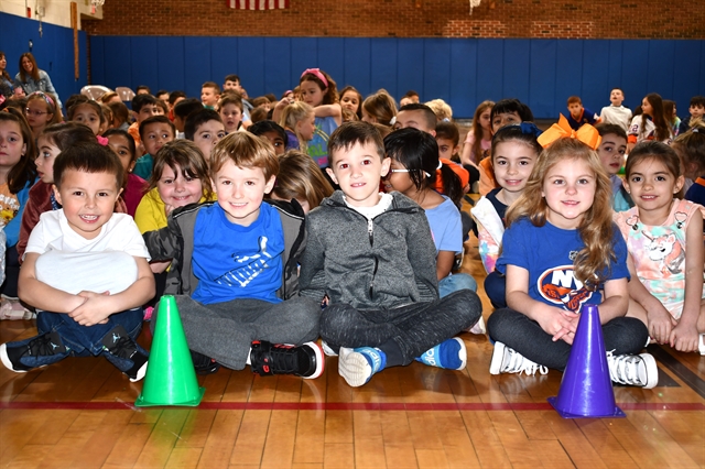 students in school sitting and watching