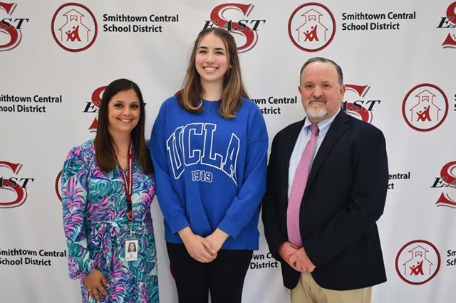 principal, student and assistant principal taking a picture