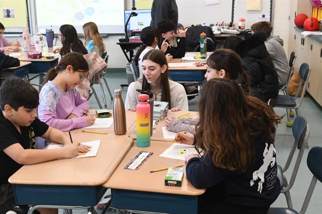 High School students in class with elementary students