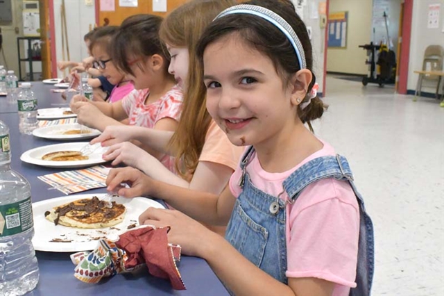 student eating pancakes