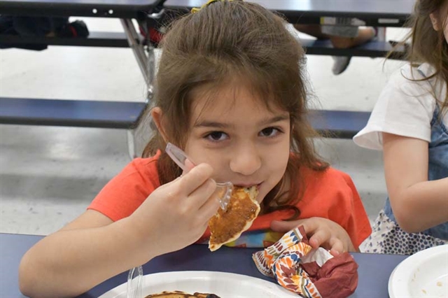 student eating pancakes