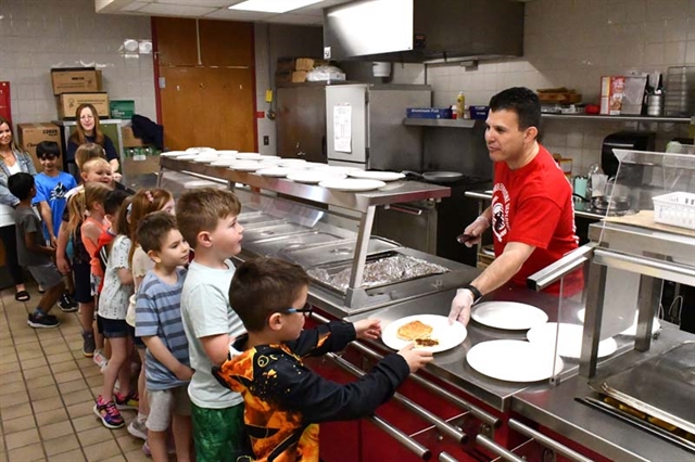 Principal Ierano serving pancakes