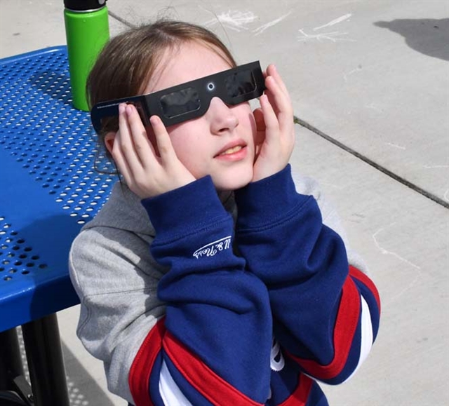 student watching the eclipse
