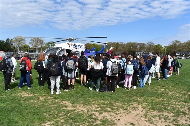 students watching helicopter