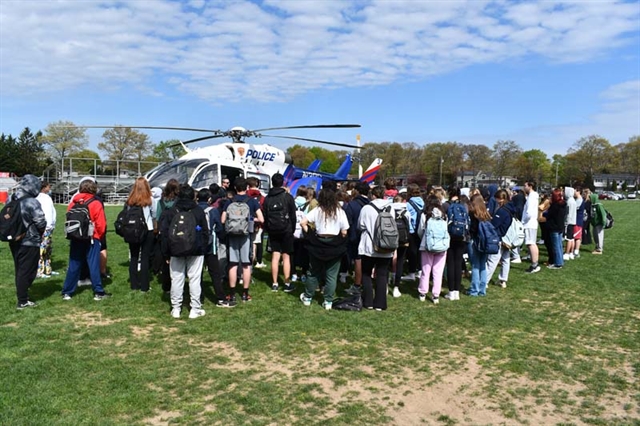 students watching helicopter