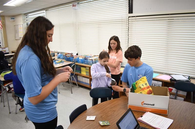 High School students helping elementary students