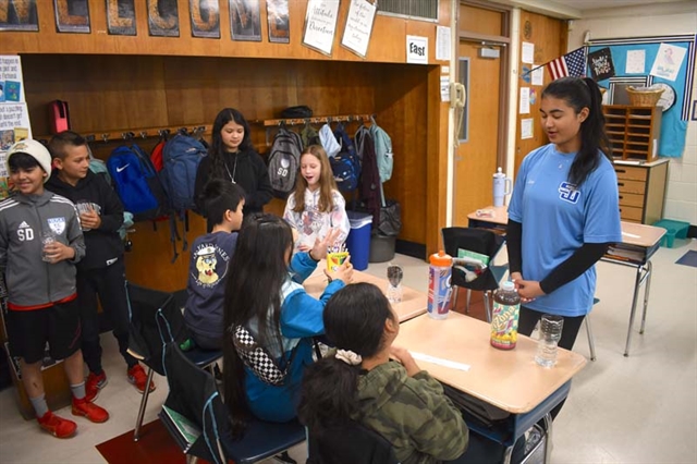 High School students helping elementary students