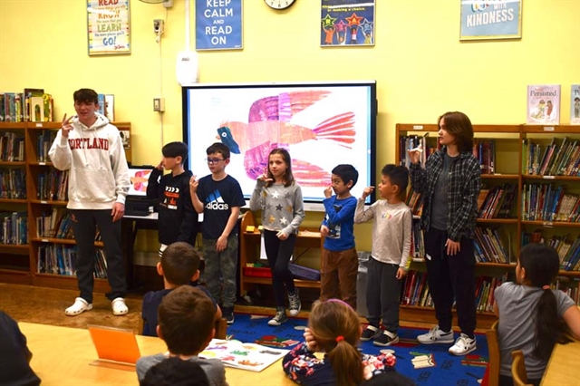 High School students and elementary students doing sign language