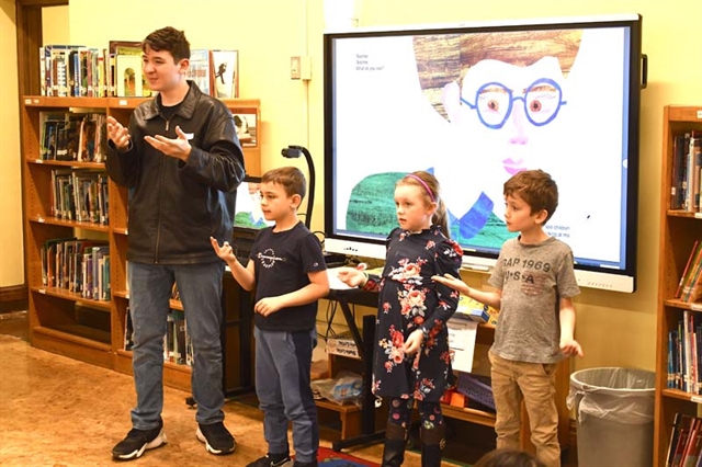 High School students and elementary students doing sign language