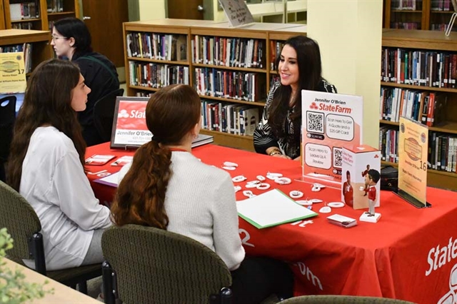 students at desk networking