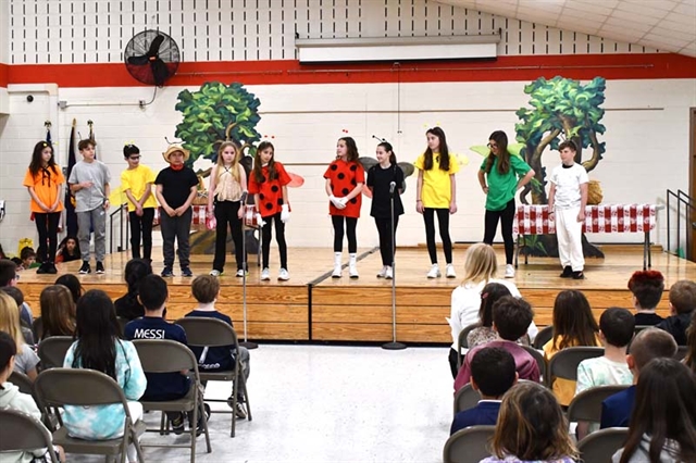 student on stage dressed as a bug