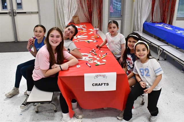 students smiling at table