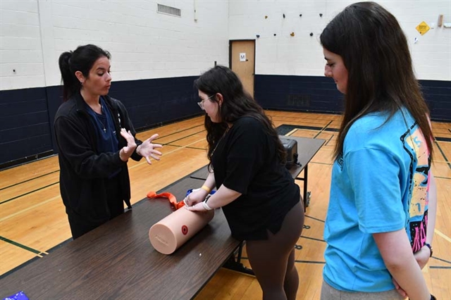 student practicing using a tourniquet