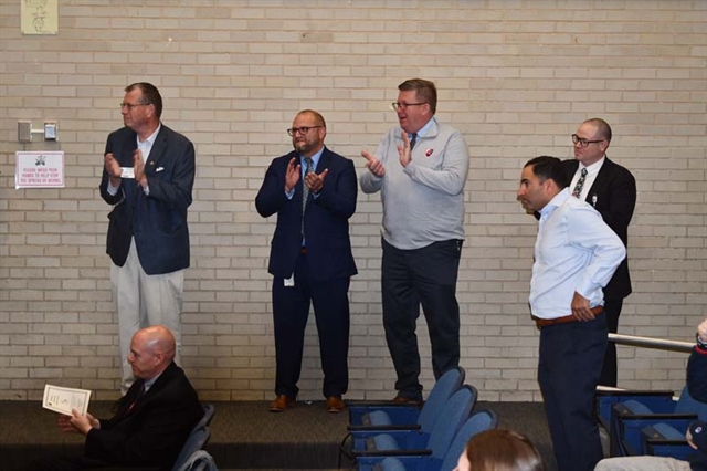 Superintendent Secaur and staff applauding