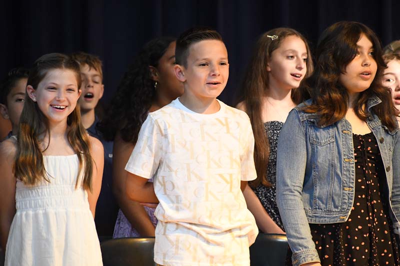 students on stage singing