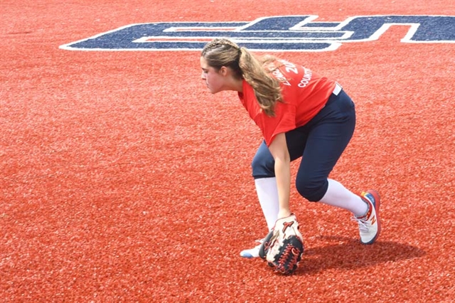 girl playing softball