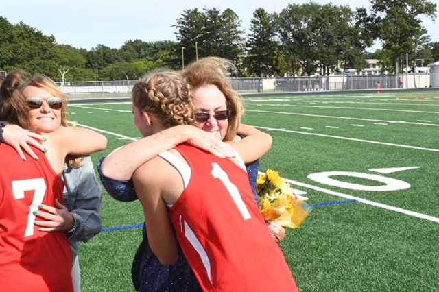 Pat Corey hugging a player