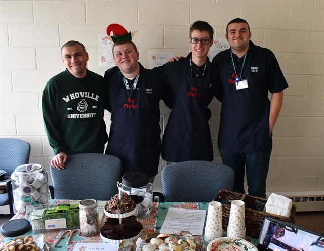 Students posing by Holiday Shop