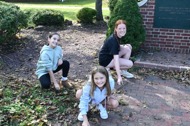 students doing a yard cleanup