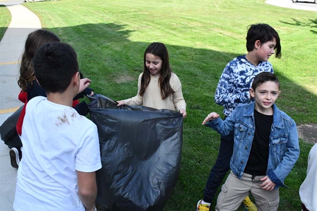 students doing a yard cleanup