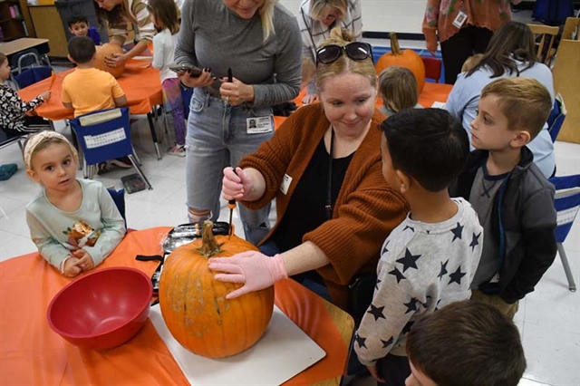Parents helping pumpkin carving