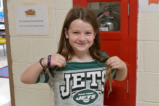 Student posing for picture wearing sports jersey