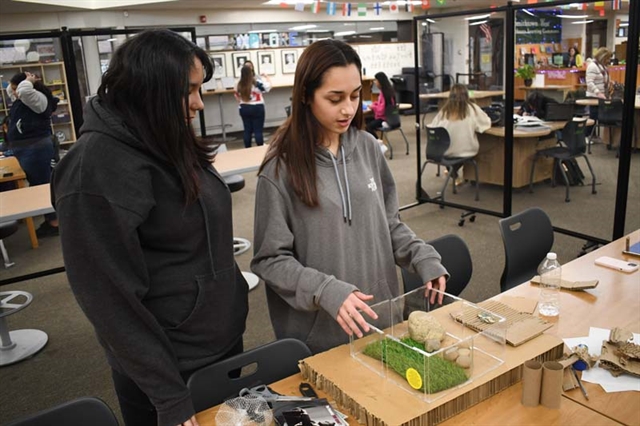 Students smiling with project