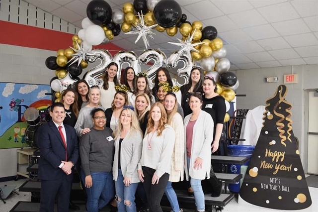 Faculty and PTA smiling for Happy New Year