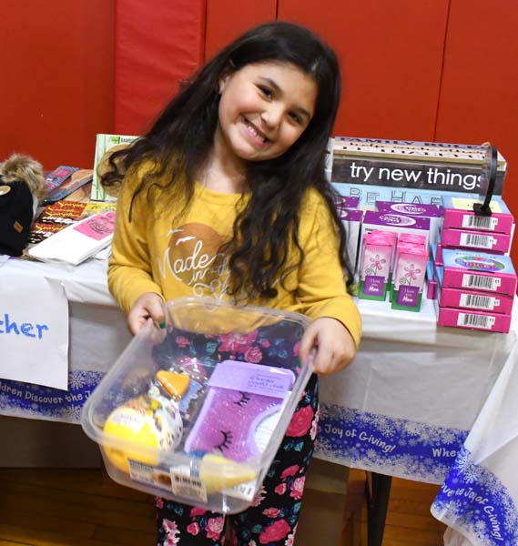 Student holding presents