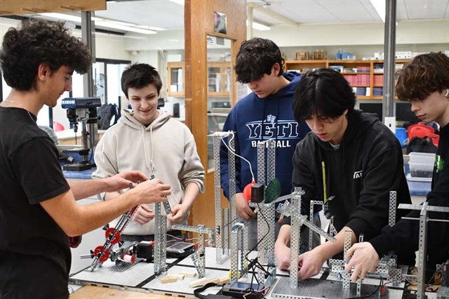 PLTW class working on a machine