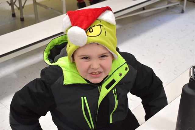 student in Grinch hat