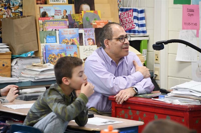 teacher and student watching presentation