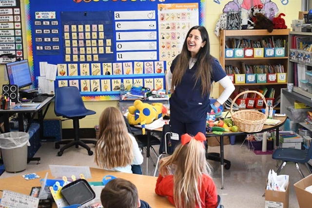 Dentist speaking with students