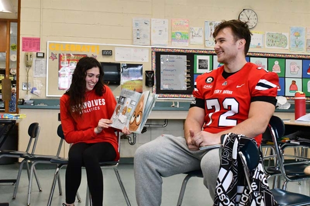 athletes reading to students