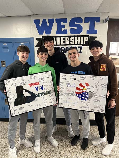 students posing with sign