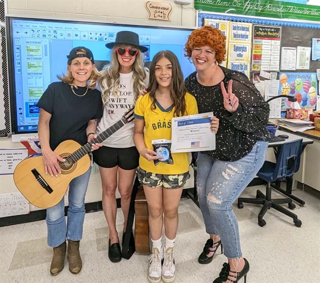 Juliana Labropoulos and teachers smiling