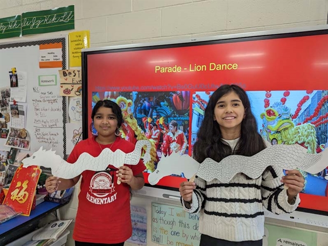 Students holding paper dragon