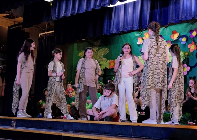 students on stage for performance