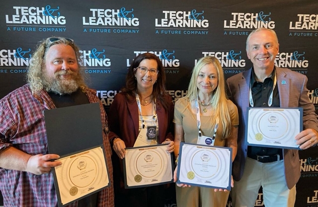 Tim Needles and others holding awards