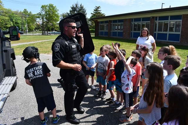 police officer talking to students