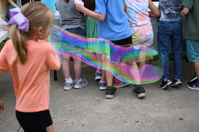 student playing with bubble