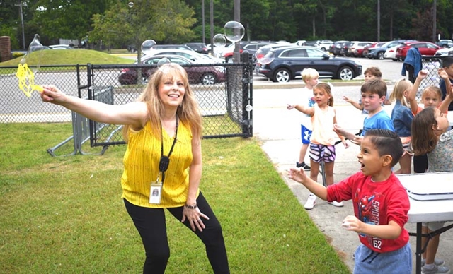 student and teacher playing with bubble