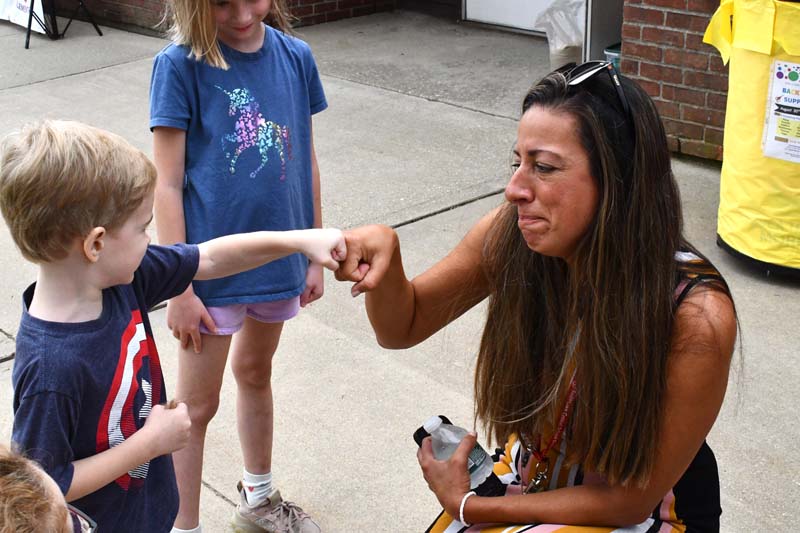 Principal giving fist bump